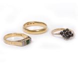 AN 18 CARAT GOLD EMERALD AND DIAMOND SET RING, an 18 carat gold wedding band, a 9 carat gold