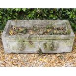 A PAIR OF CAST RECONSTITUTED STONE RECTANGULAR TROUGHS OR PLANTERS with lion mask decoration to