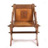 A CARVED OAK AND PEGGED GLASTONBURY CHAIR with carved mottos to the arms and back, 70cm wide x