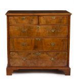 AN 18TH CENTURY WALNUT VENEERED CHEST OF TWO SHORT AND THREE LONG DRAWERS with brass handles and