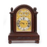AN EARLY 20TH CENTURY GEORGIAN STYLE MAHOGANY CASED BRACKET OR TABLE CLOCK with arching case and