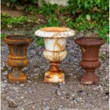 A PAIR OF SMALL CAST IRON URNS of campana form, each 22cm diameter x 31cm high together with a