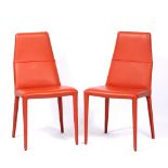 A PAIR OF MODERNIST ORANGE LEATHERETTE UPHOLSTERED HIGH BACKED CHAIRS with four tapering legs 44cm