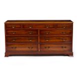 A 20TH CENTURY YEW WOOD VENEERED SIDEBOARD with nine drawers, swan neck handles and on bracket feet,