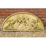 A D SHAPED CAST RECONSTITUTED STONE PLAQUE depicting cavorting putti, 116cm wide x 52cm high