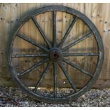 AN OLD WOODEN CART WHEEL with iron tyre, 114cm diameter Condition: wear to the paint and general