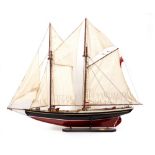A PAINTED WOODEN MODEL OF A TWO MASTED SAILING SHIP 'The Delawana', with painted hull and cloth