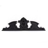 A BLACK PAINTED CARVED WOODEN CRESTING OR BREAK ARCH PEDIMENT in the Gothic Revival style and carved