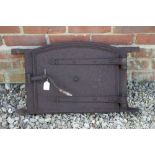 A 19TH CENTURY CAST IRON BREAD OVEN DOOR AND FRAME with moulded strapwork hinges, 62cm wide x 36cm