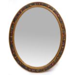 A 1930'S BARBOLA OVAL WALL MIRROR with a bevelled mirror plate and a Maples Depository label to