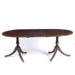 A REGENCY STYLE MAHOGANY D END TILT TOP TWIN PEDESTAL DINING TABLE with crossbanded decoration to