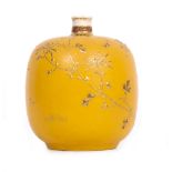 AN EARLY 20TH CENTURY JAPANESE POTTERY BOTTLE VASE of squat form with a yellow ground and gilded