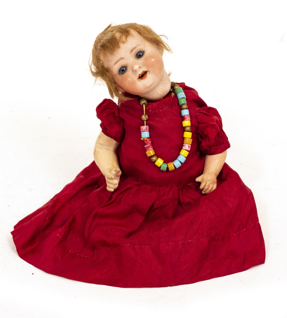 A GERMAN PORCELAIN HEADED DOLL by Heubach Koppelsdorf, stamped to the reverse with the makers name