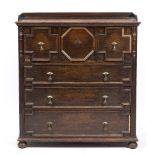 A MID 20TH CENTURY JACOBEAN STYLE OAK SECRETAIRE CHEST with mitered decoration to the drawer