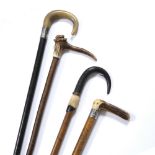 FOUR HORN AND ANTLER HANDLED WALKING CANES two with silver collars Condition: the silver collars