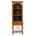A WILLIAM AND MARY STYLE WALNUT NARROW GLAZED CABINET ON STAND with two shelves, the stand with
