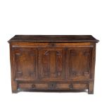 AN ANTIQUE OAK PANELLED MULE CHEST with moulded decoration to the front panels above a single