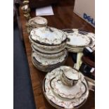 A PART DINNER SERVICE retailed by Maple & Co with a graduated set of five meat platters, the largest