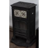 A VICTORIAN CAST IRON STOVE with tile inset panel to the front and shaped base, 51cm wide x 52cm