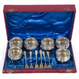 A 19TH CENTURY RED LEATHER BOX containing six white metal salts with matching shovels, all