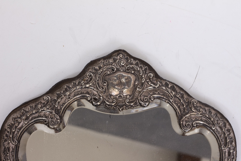 A VICTORIAN EMBOSSED SILVER MOUNTED DRESSING TABLE MIRROR with shaped and bevelled glass, 34cm - Image 3 of 4