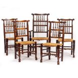 A SET OF FIVE ELM SPINDLE BACK NORTH COUNTRY STYLE DINING CHAIRS with rush seats consisting of a