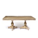 A RECTANGULAR PAINTED AND PARCEL GILT DINING TABLE with twin pedestal supports, with faceted