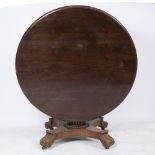 A WILLIAM IV CIRCULAR ROSEWOOD DINING TABLE with reeded central column, platform base and four