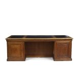 A LARGE EARLY 20TH CENTURY OAK PEDESTAL PARTNERS DESK with a leatherette inset top, each pedestal