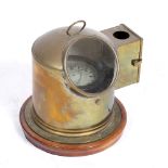 A GIMBALED SEA COMPASS in a brass surround with an oil lamp fitting, 25cm wide x 25cm high