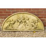 A D SHAPED CAST RECONSTITUTED STONE PLAQUE depicting cavorting putti, 116cm wide x 52cm high