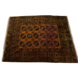 A MIDDLE EASTERN ORANGE GROUND LARGE RUG with a multiple banded border, geometric decoration and