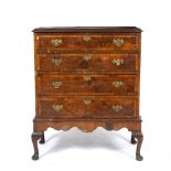 A GEORGIAN STYLE WALNUT CHEST ON STAND with four drawers, each with pierced brass handles, the
