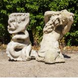 A CAST RECONSTITUTED STONE SCULPTURE OR FOUNTAIN HEAD depicting Triton blowing on a shell, the