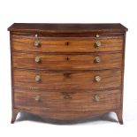 AN EARLY 19TH CENTURY MAHOGANY BOW FRONTED CHEST OF FOUR GRADUATED DRAWERS beneath a baize inset