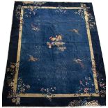 A CHINESE BLUE GROUND CARPET with exotic birds and a gold border, 300cm x 380cm Condition: