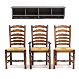 A SET OF THREE OAK LADDER BACK DINING CHAIRS with rush seats by Brights of Nettlebed, consisting