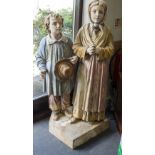 A 19TH CENTURY TERRACOTTA FIGURAL GROUP of a boy and a girl on a plinth base, 123cm high overall