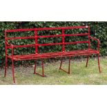 A RED PAINTED WROUGHT IRON GARDEN BENCH 167cm wide x 82.5cm deep Condition: seemingly recently