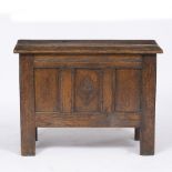 A SMALL SIZED OAK PANELLED COFFER with diamond shaped chip carved decoration to the front and