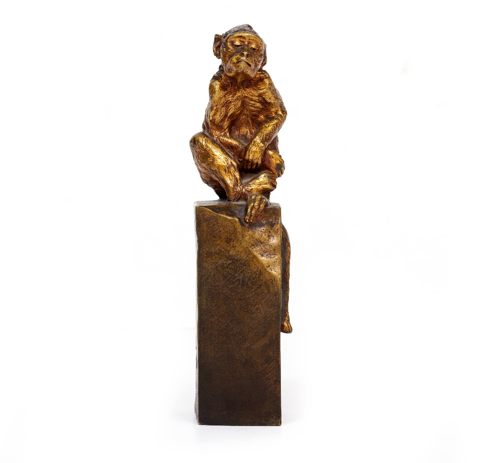 A BRASS CROUCHING MONKEY on a plinth, signed 'M Max' to side and '23v' to back, 24.5cm high