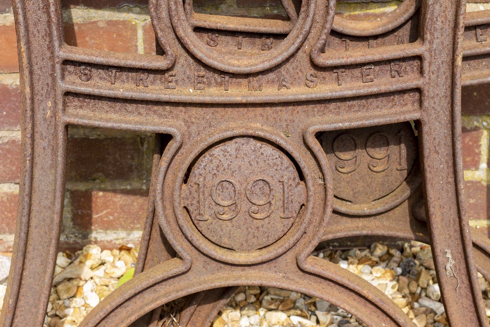 A PAIR OF 'STREET MASTER' CAST IRON BENCH ENDS each with a roundel bearing the date 1991 and each - Image 2 of 3
