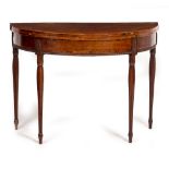 A GEORGE III MAHOGANY D SHAPED FOLD OVER CARD TABLE with cross banded decoration, carved frieze