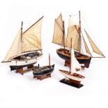 A COLLECTION OF MODEL BOATS AND MODEL AEROPLANES to include an early 20th century pond yacht and a