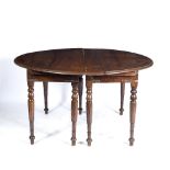 AN OLD HARDWOOD CIRCULAR DINING TABLE with folding turned supports, 140cm wide x 76cm high