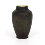 AN AUSTRIAN POTTERY VASE with a dark green luster star glaze, 18cm wide x 30cm high Condition: