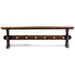 A VICTORIAN OAK BENCH with shaped end supports and pierced trefoil decoration to the stretcher,