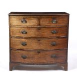 A GEORGE III MAHOGANY BOW FRONTED CHEST OF TWO SHORT AND THREE LONG DRAWERS with oval brass