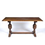 A JACOBEAN STYLE MID 20TH CENTURY OAK RECTANGULAR KITCHEN TABLE the plank top with cleated ends on