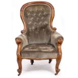 A VICTORIAN WALNUT FRAMED UPHOLSTERED ARMCHAIR with scrolling arms, cabriole legs and brass and